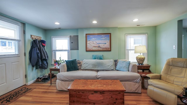 living room featuring visible vents, light wood-style flooring, and recessed lighting