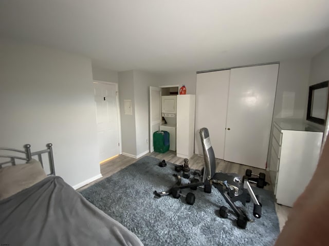 bedroom with a closet, wood finished floors, and baseboards