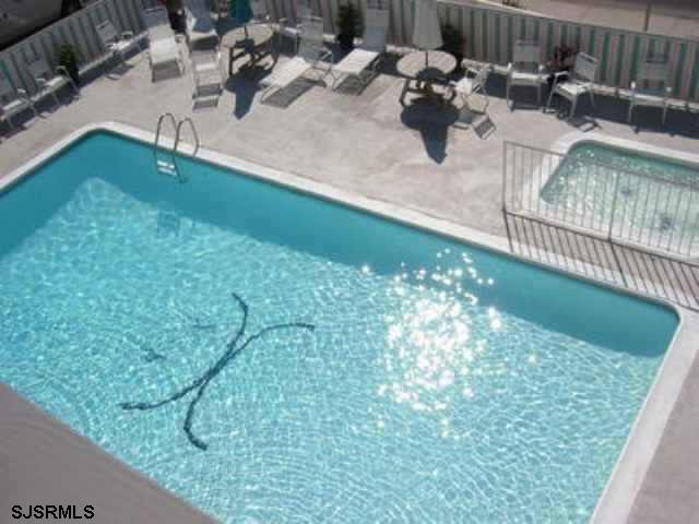 view of swimming pool with a patio area, fence, and a fenced in pool