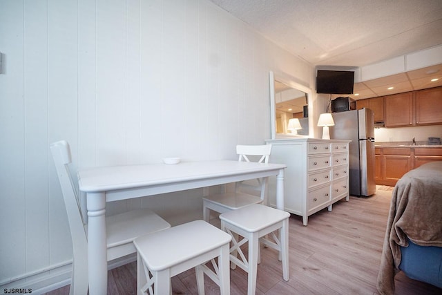 interior space featuring light wood-style floors, freestanding refrigerator, and a sink