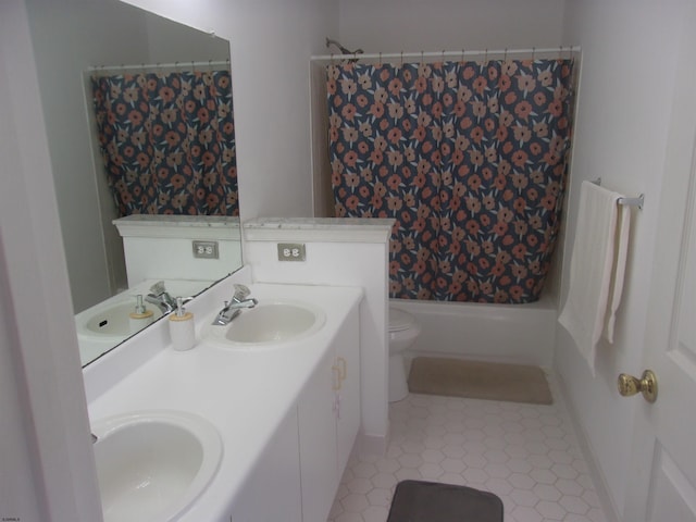 full bathroom featuring shower / bath combination with curtain, a sink, and toilet