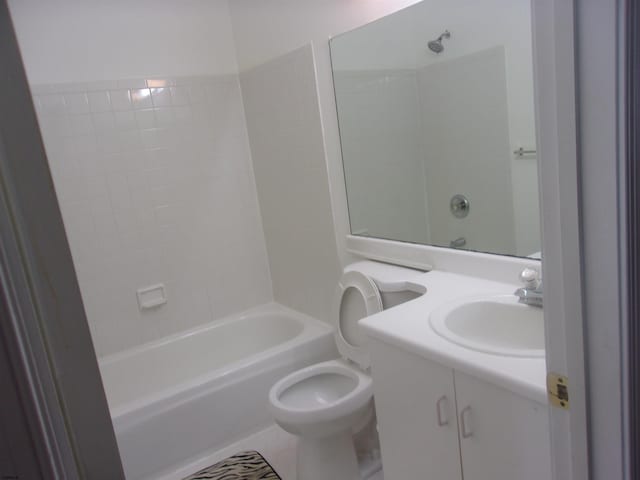 full bathroom featuring shower / bathing tub combination, vanity, and toilet