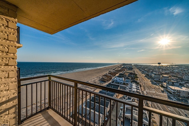 balcony featuring a water view and a beach view