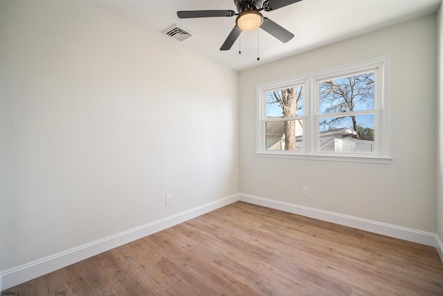 unfurnished room featuring ceiling fan, light wood finished floors, visible vents, and baseboards