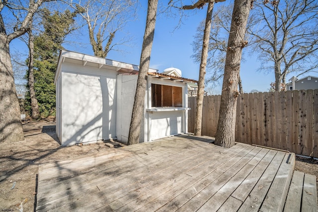 deck featuring fence and an outdoor structure