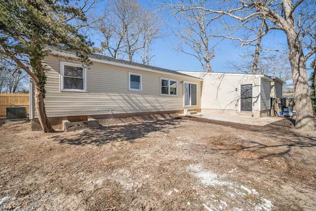 back of property featuring entry steps, a patio, fence, and central AC unit