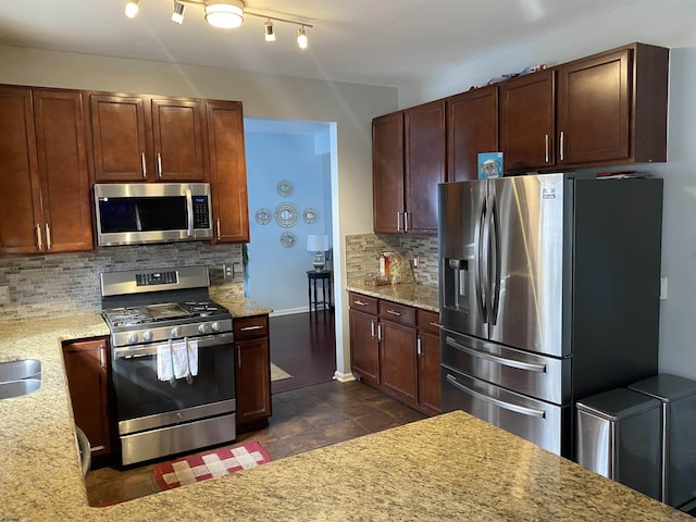 kitchen featuring a sink, light stone countertops, stainless steel appliances, and backsplash