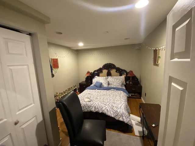 bedroom with wood finished floors and recessed lighting