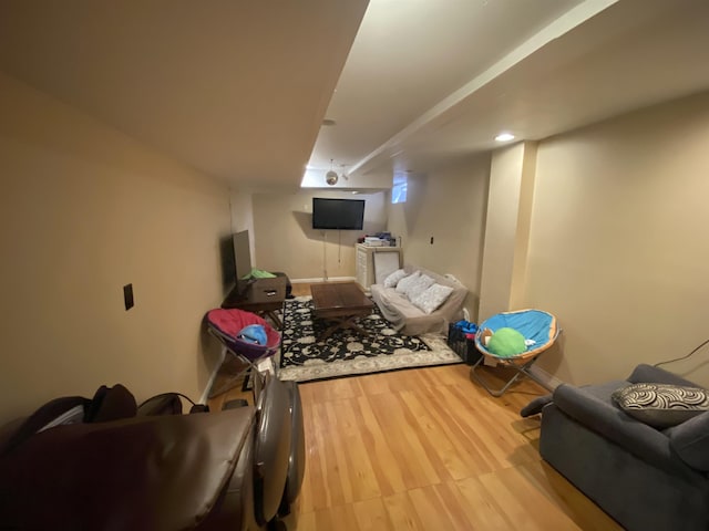 exercise area featuring light wood-type flooring and baseboards