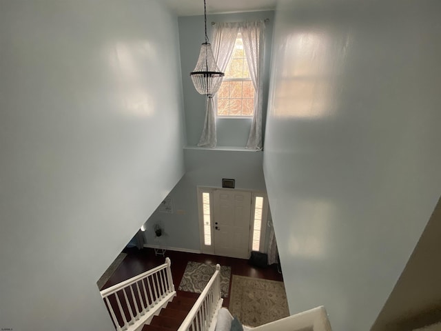 staircase featuring a high ceiling and wood finished floors