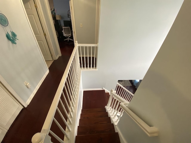 stairs with baseboards and wood finished floors