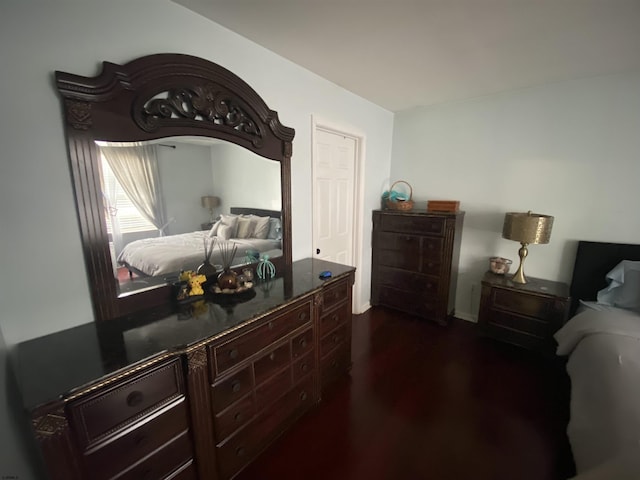 bedroom with dark wood finished floors