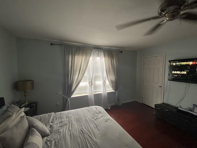 bedroom with dark wood finished floors and a ceiling fan