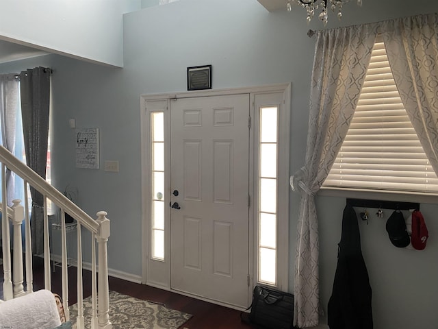 entryway with dark wood-style floors and stairway