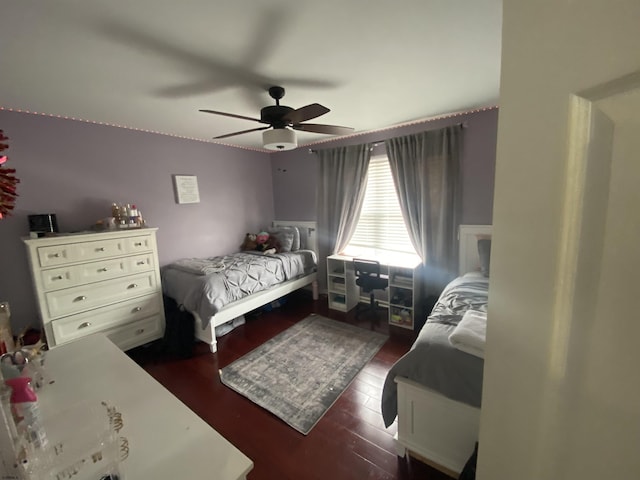 bedroom with dark wood-style floors and a ceiling fan