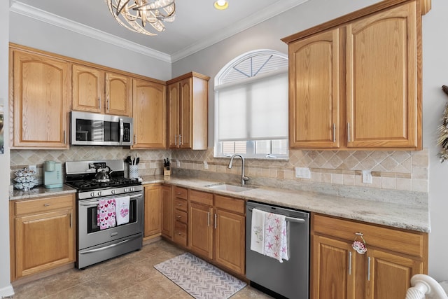 kitchen featuring light stone counters, a sink, ornamental molding, appliances with stainless steel finishes, and tasteful backsplash