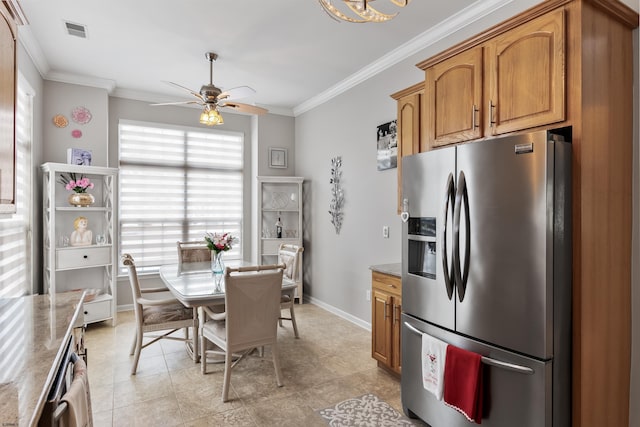 kitchen with visible vents, ornamental molding, stainless steel refrigerator with ice dispenser, brown cabinetry, and dark stone countertops