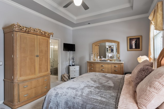 bedroom with crown molding, a raised ceiling, visible vents, ensuite bathroom, and light carpet