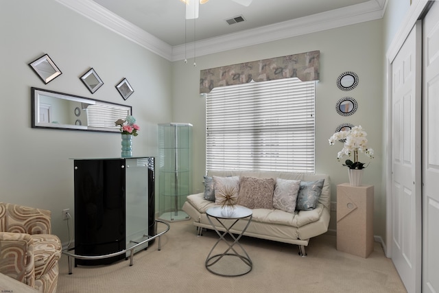 sitting room featuring carpet floors, visible vents, and crown molding