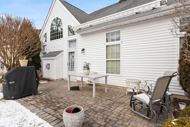 view of patio / terrace featuring an outdoor structure and a grill