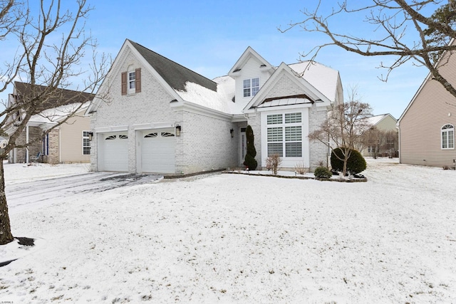 traditional home featuring a garage, brick siding, and driveway