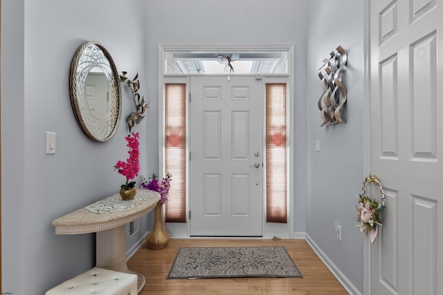 entryway featuring baseboards and light wood finished floors