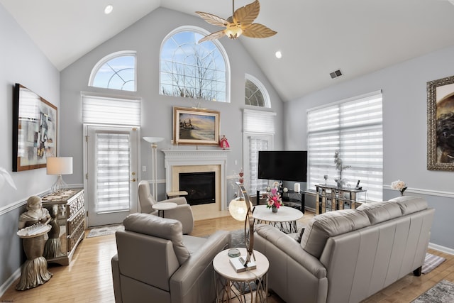 living room featuring visible vents, plenty of natural light, and a premium fireplace