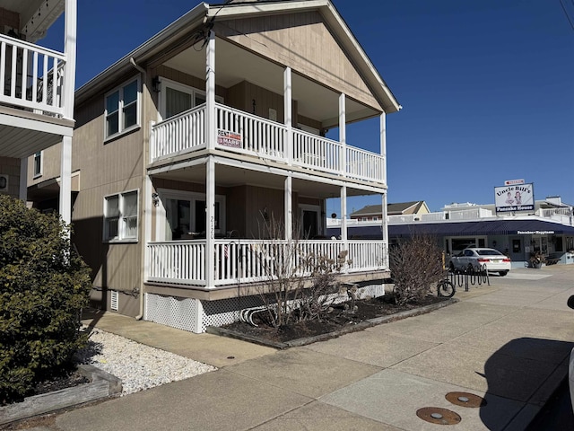 view of front of home with a porch and a balcony