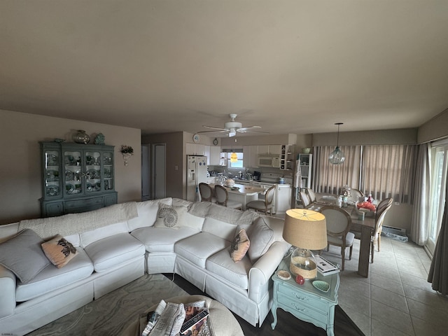 living room with a healthy amount of sunlight, tile patterned flooring, and ceiling fan