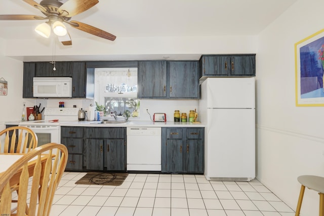 kitchen with light tile patterned floors, light countertops, a ceiling fan, a sink, and white appliances