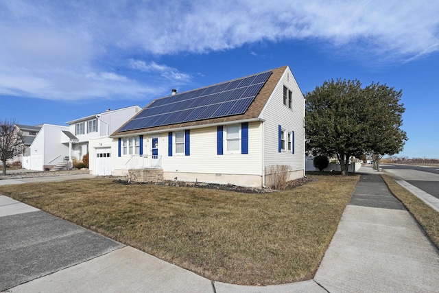 view of front of house featuring solar panels, a shingled roof, and a lawn