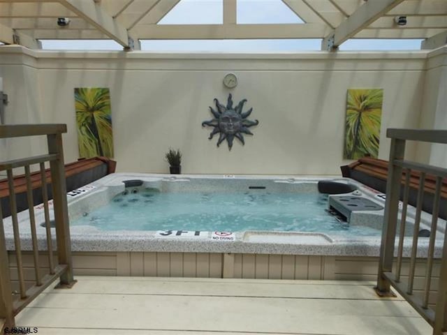 view of pool featuring an outdoor hot tub