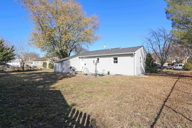 rear view of house with a lawn