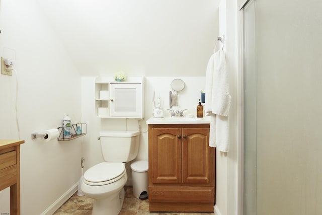 bathroom with baseboards, vanity, and toilet