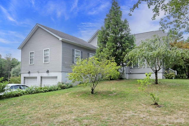 view of home's exterior with a lawn and an attached garage