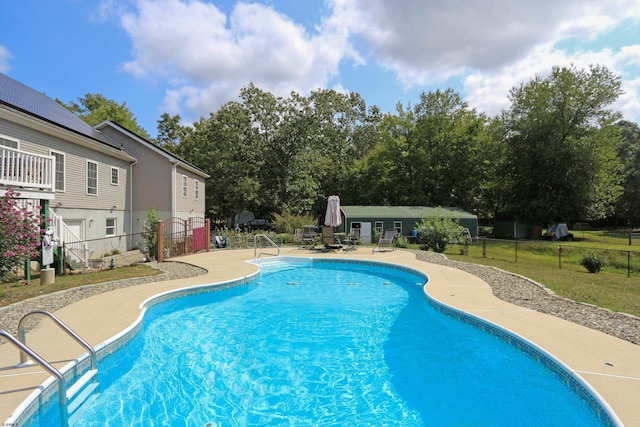 view of swimming pool featuring a fenced in pool, a patio area, and fence