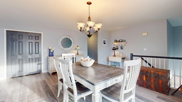 dining room featuring light wood-style floors and a chandelier