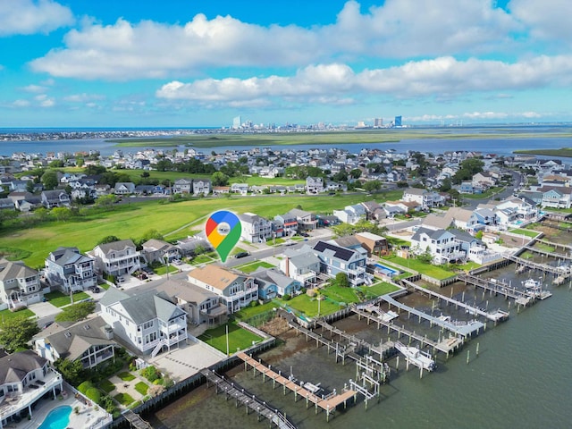 drone / aerial view with a residential view and a water view