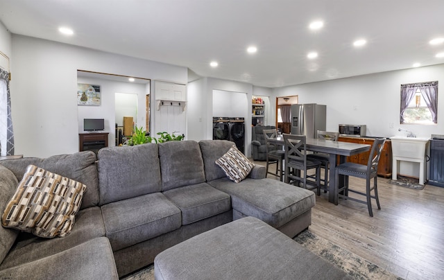 living area with wood finished floors and recessed lighting