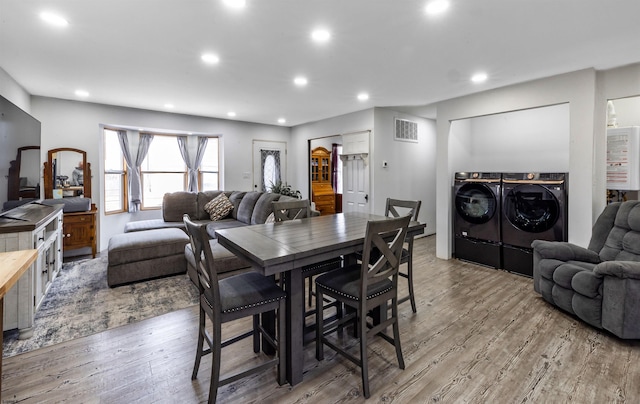 dining area with recessed lighting, wood finished floors, visible vents, and washer and dryer