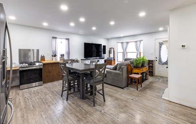 dining room with light wood-style floors and recessed lighting