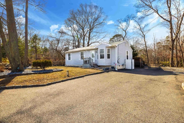 ranch-style house with aphalt driveway