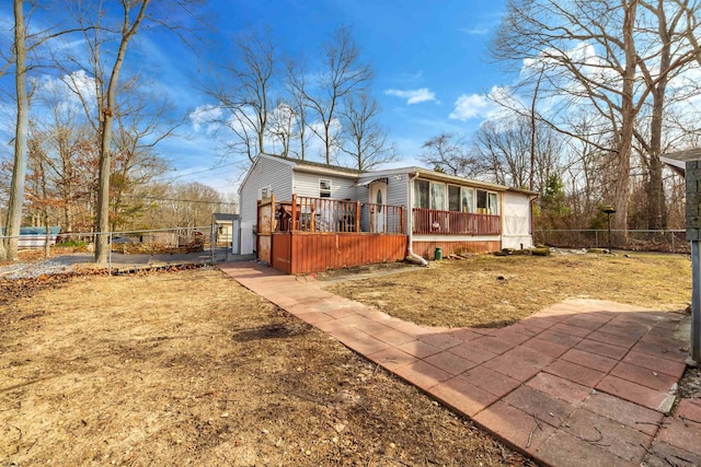 view of front of home with fence private yard and a wooden deck