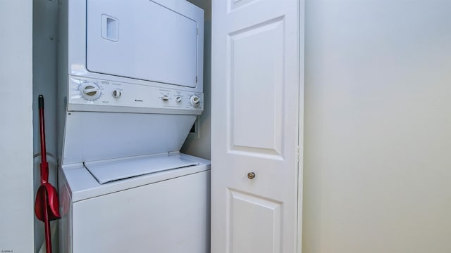 washroom with stacked washer and dryer and laundry area