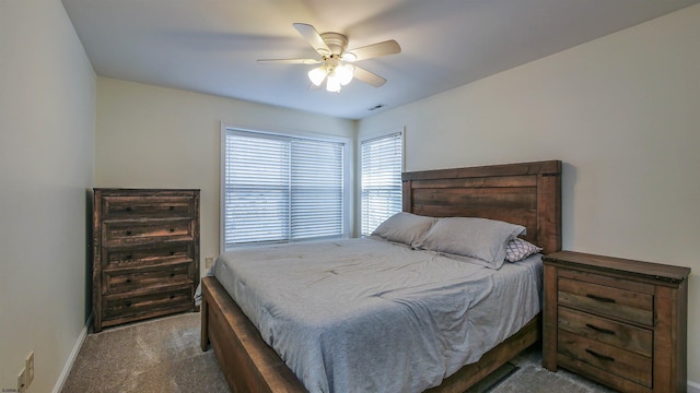 carpeted bedroom featuring ceiling fan, visible vents, and baseboards