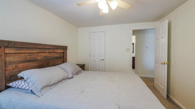 bedroom featuring light carpet, baseboards, and a ceiling fan