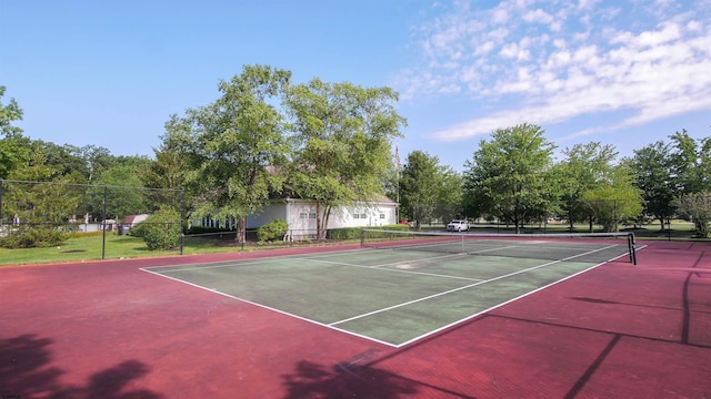 view of tennis court featuring fence