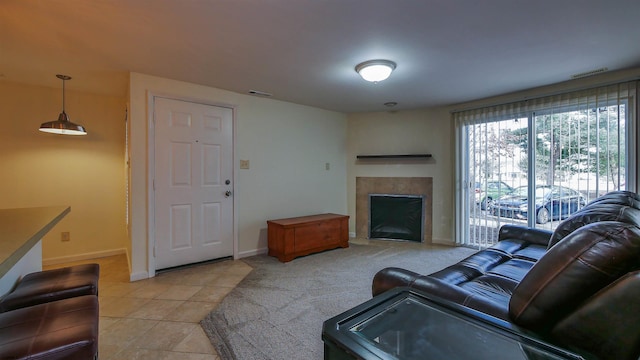 living room with a fireplace, light tile patterned floors, light colored carpet, visible vents, and baseboards