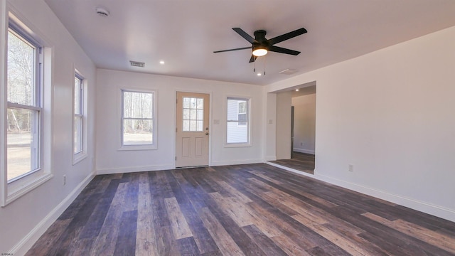 foyer entrance with dark wood-style floors, visible vents, ceiling fan, and baseboards