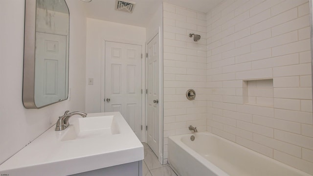 bathroom with a closet, visible vents, vanity, and bathtub / shower combination